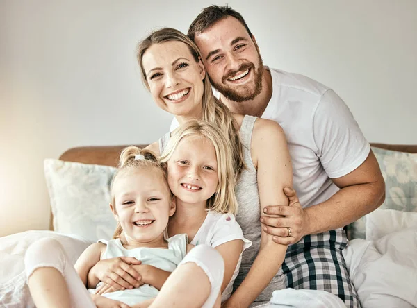 Happy, love and portrait of family on the bed for bonding and relaxing together at modern home. Happiness, smile and girl children sitting with mother and father from Australia in bedroom at house