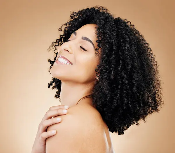 Woman, happy and beauty, hair and natural curls, salon treatment and shine, healthy skin glow on studio background. Skincare, dermatology and clean makeup, haircare and texture with afro and smile.