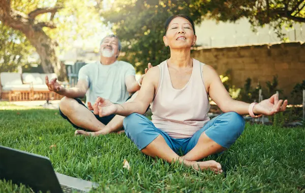 Couple, yoga and lotus meditation with laptop in nature at park for mindfulness, peace and calm. Mature man, woman and yogi on computer for online lesson on video, wellness and zen for body health.
