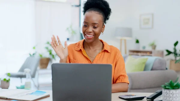 Laptop, wave and black woman on video call in home, online meeting or webinar with smile. Communication, notebook and happy freelancer or remote worker in virtual chat for greeting and discussion