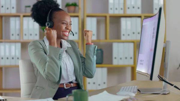 Excited black woman, call center and fist pump in winning, promotion or success for customer service at office. Happy African female person, consultant or agent smile in celebration for online bonus.