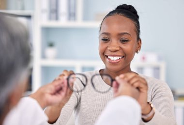 Black woman, patient and doctor with glasses, eye care and vision consultation with optometrist, appointment and choice. Prescription lens, frame and help with smile, advice and optometry healthcare. clipart