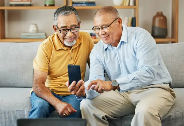 Home, friends and old men with a smartphone, typing and connection with social media, post and relax. Mature guys, digital app or pensioners with a cellphone, mobile user or contact with sms or email.