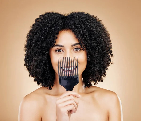 Hair, comb and portrait of woman with afro for style isolated in a studio brown background for wellness and skincare. Texture, natural and young person with cosmetic aesthetic in Brazil hairdresser.