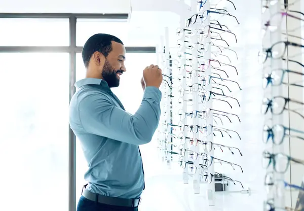 Ophthalmology, glasses and man for eye care decision, choice and options in optician store for vision. Healthcare, optometry and person in clinic to choose prescription lens, spectacles and frames.