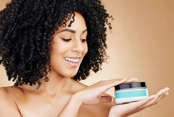 Woman, container and hair, product for curls and shine, beauty with smile and strong texture on studio background. Advertising, haircare cosmetics for growth and cosmetology with model and afro.