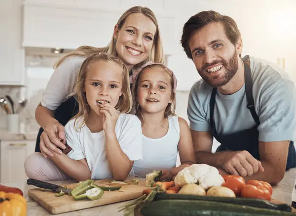 Portrait, cooking and happy family in kitchen together for bonding and preparing dinner, lunch or supper. Love, smile and girl children cutting vegetables or ingredients with parents for meal at home.