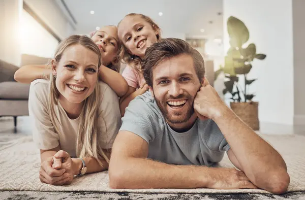 Home, portrait and family with girls on the floor, relax and happiness with joy, cheerful and weekend break. Children, mother or father with kids on the ground, calm or care with a smile in a lounge.