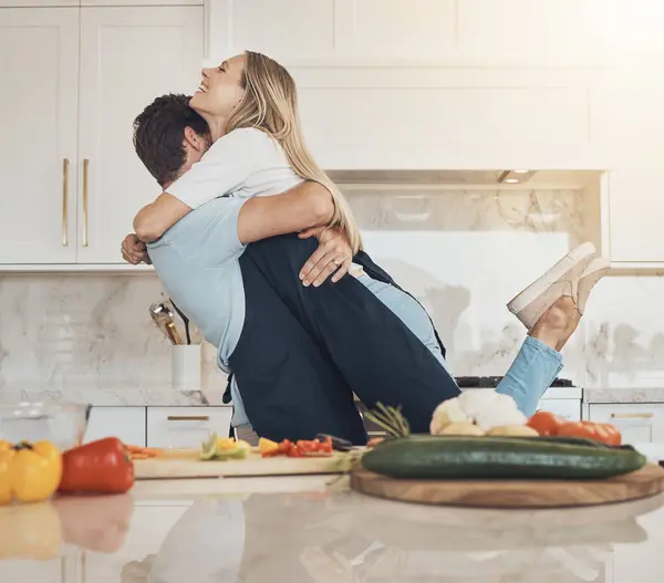 Cooking, hug or happy couple with love or food for a healthy vegan diet, supper or meal together at home. Smile, laugh or woman in kitchen to bond with wellness or man at dinner for lunch or support.