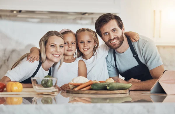Love, portrait and family cooking in kitchen together for bonding and preparing dinner, lunch or supper. Happy, smile and girl children and parents with vegetables or ingredients for meal at home