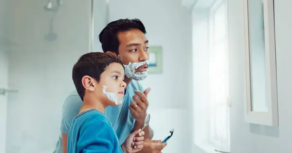 Shaving cream, child and father teaching in bathroom, family home or boy learning morning skincare, beauty and grooming routine. Shave together, son and dad helping with foam, razor and skin care.