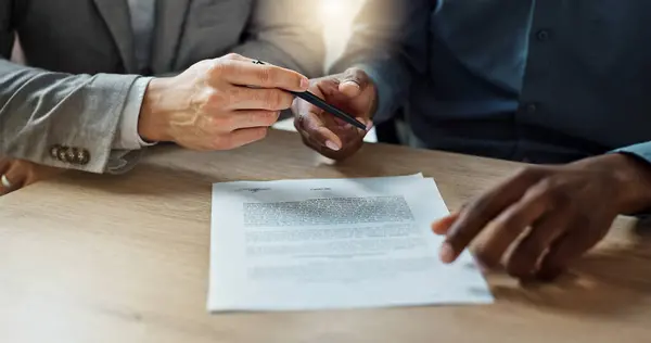 Business, hands and writing signature on contract or legal documents for application or agreement in office. Explain, pointing and person show paperwork or form to client in workplace or company.