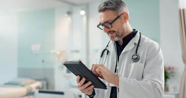 Healthcare, senior man and doctor with a tablet, typing or research with online results, digital app or internet. Person, employee or medical professional with technology, connection and website info.