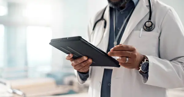 Closeup, man and doctor with a tablet, internet or connection with online results, digital app or typing. Person, employee or medical professional with technology, healthcare or website information.