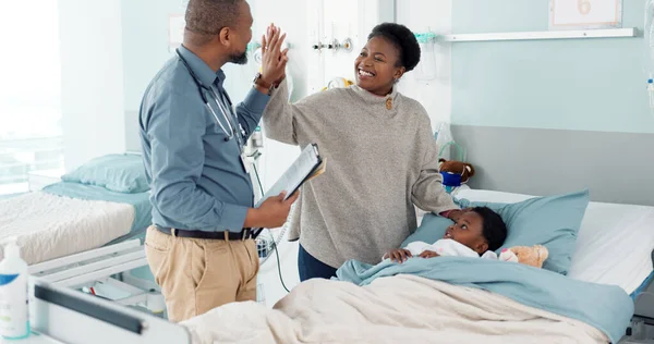 Doctor, high five and child in hospital, bed or healing in clinic with results or celebration in surgery rehabilitation. Happy, kid and surgeon support patient, mother and success in healthcare.