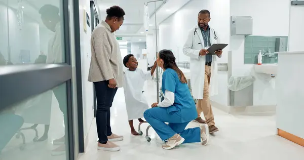 Black family, medicine and a pediatrician talking to a patient in the hospital for medical child care. Kids, trust or healthcare and a nurse consulting a boy with his mother in the clinic for health.