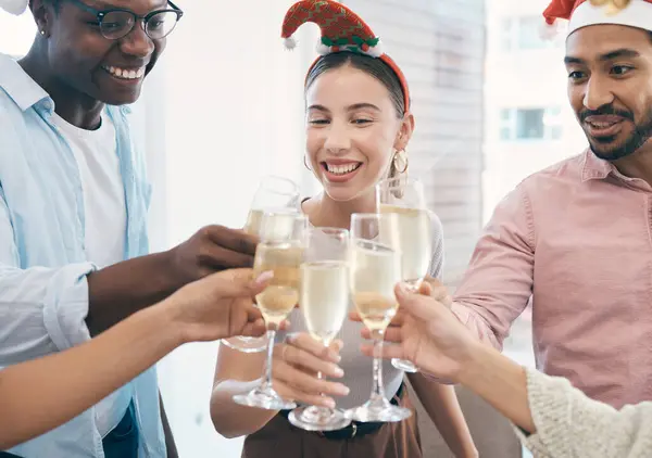 Champagne, Christmas party and toast with group of people at office, celebration and fun with holiday and alcohol. Wine, cheers and employees at work event for Xmas, happy and diversity with drinks.