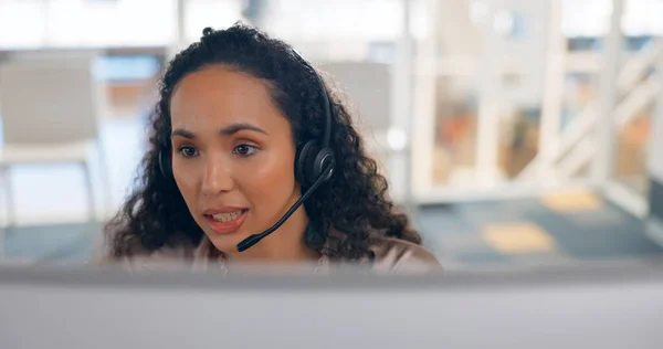 Face, computer and a woman in a call center for customer service or support with a headset microphone. Contact us, crm or telemarketing with a young consultant talking for help or assistance.