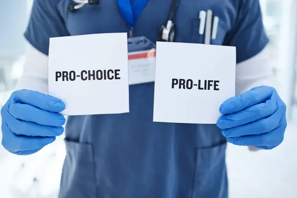 Life, choice and doctor with paper in hands for abortion, human rights or decision in clinic. Nurse, poster and vote for women with option for family planning in hospital or medical contraception.