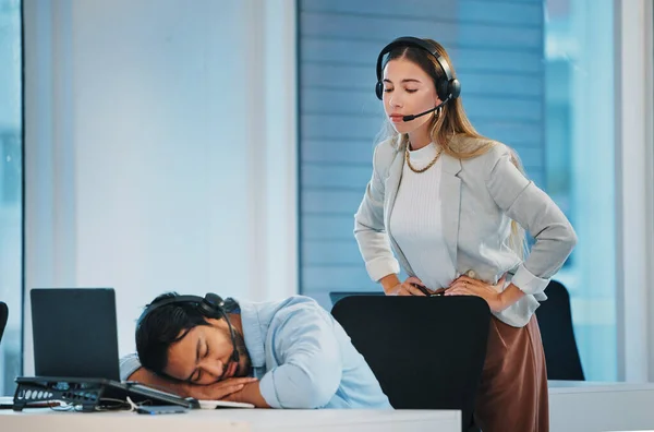 Boss, lazy and man employee in office at laptop telemarketing center, sleep or burnout. Woman manager, worker and headset or person tired rest at desk, overworked or fatigue for customer service.