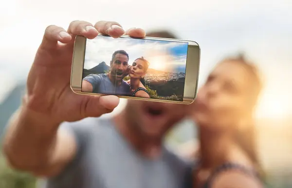 Phone screen, selfie and portrait of couple in nature outdoor on summer vacation together. Mobile, face and picture of excited man and woman at park for connection, memory of love and relationship.