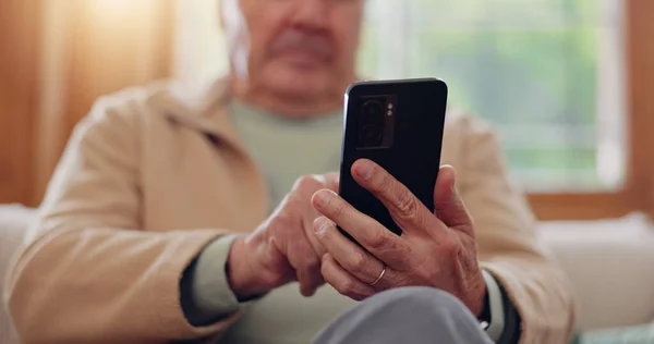 Parkinsons, smartphone and hands of senior man typing online on internet search in retirement home. Phone, elderly person with a disability and scroll on health website, communication or social media.