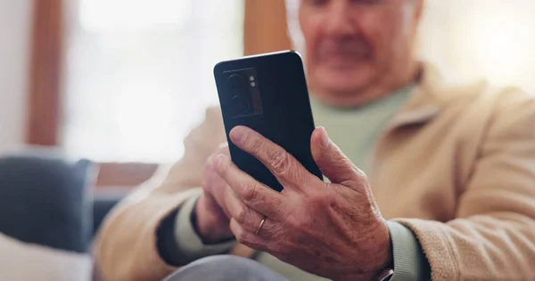 Smartphone and hands of senior man typing online on internet search in retirement home. Phone, elderly person ecommerce and scroll on health website, communication or social media.