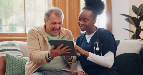 Senior, man and nurse with tablet for consulting, medical information and communication with laughing. Elderly, professional and caregiver with touchscreen for online report, advisory and results or .
