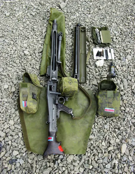 Military, weapon and gun with cleaning kit on ground outdoor for service, mission or protection of soldier. Rifle, sniper or pistol for maintenance, danger or shooting on battlefield or operation.