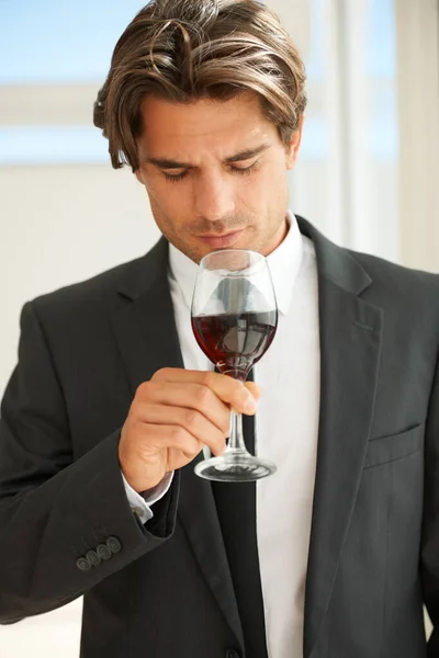 Glass of red wine, glass and man with promotion, thinking and celebration with event, aroma and suit. Rich, guy and expert with alcohol, idea and luxury with beverage, drink and winery with scent.