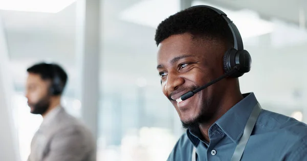 Happy black man, call center and customer service in telemarketing, communication or support at office. African male person or consultant agent smile in online advice, help or contact us at workplace.