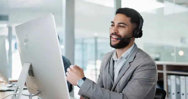 Call center, customer service and man on an online consultation on a computer working in the office. Contact us, crm and young male telemarketing consultant or agent talking for support in workplace