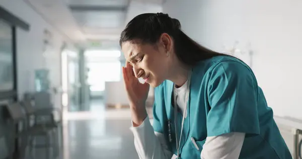 Stress, sad and loss with a woman nurse in hospital after a fail, mistake or error in healthcare treatment. Depression, anxiety and grief with a young medicine professional in a medical clinic.
