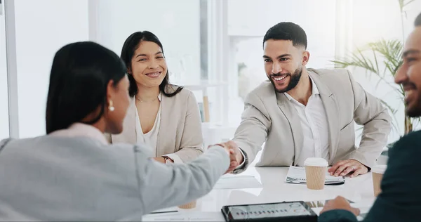 Happy businessman, handshake and meeting in b2b, deal agreement or promotion in team conference at office. Business people shaking hands in greeting, introduction or partnership together at workplace.
