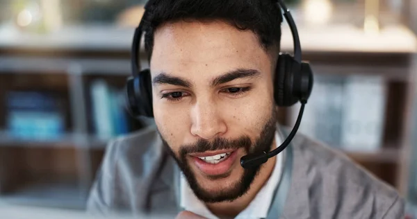 Businessman, face and consulting in call center, support or customer service at office. Closeup of man, consultant or agent talking on headphones for online advice, help or communication at workplace.
