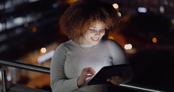 Tablet, city balcony and laughing woman reading funny social network feedback, customer experience or website. Brand monitoring data, night review or African media worker doing online survey analysis.