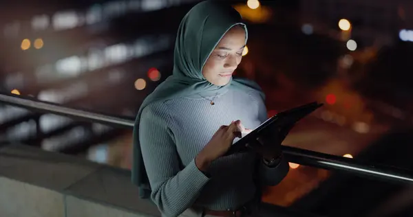 Balcony, tablet and night woman reading social network feedback, customer experience or e commerce. Brand monitoring data, Islamic info and Muslim media worker typing online survey review.