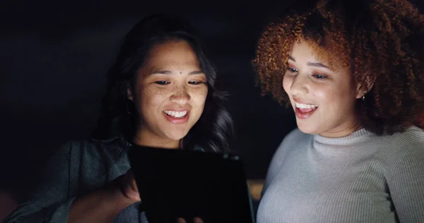 Tablet, night balcony and diversity women review social network feedback, customer experience or web ecommerce. Brand monitoring data, teamwork and media team collaboration on online survey analysis.