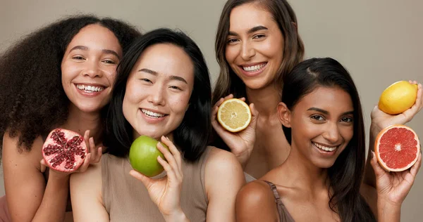 Women, portrait and beauty, diversity and fruit with dermatology and friends on studio background. Unique skin, natural cosmetics and inclusion, eco friendly skincare, smile and citrus for vitamin c.