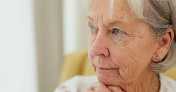 Senior woman, sad face and thinking at home with hands on chin to remember memory in retirement. Serious and upset elderly person at a nursing facility shaking head for negative emotion or Alzheimer.