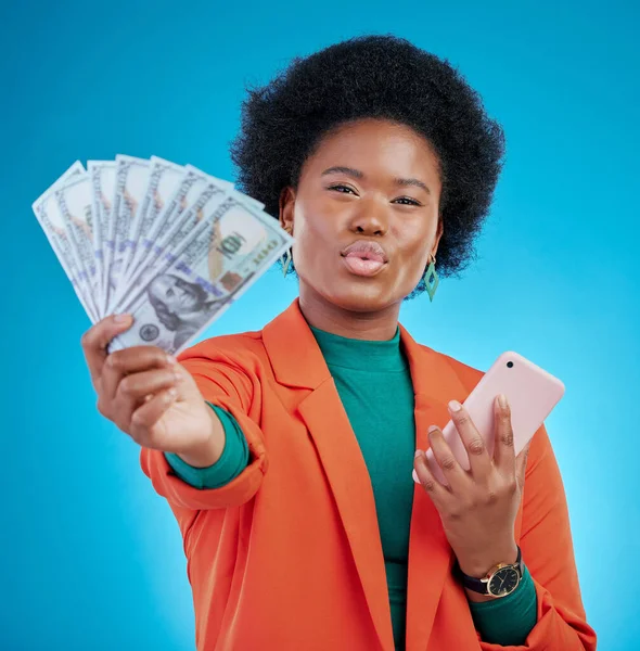 Money, phone and woman in portrait winning, finance or online savings, profit or cash prize. Success, lottery and winner or african person on mobile, cashback fan or banking on blue studio background.