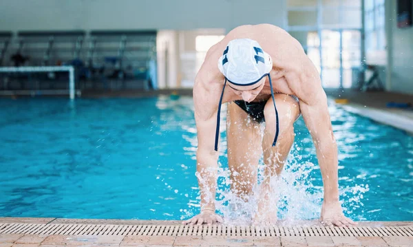 Swimming, pool and man training in water polo for fitness, sports or healthy and strong shoulders of athlete in competition or gym. Swimmer, champion or wet body in swimwear and cap with muscles.
