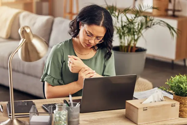 stock image Wrist pain, stress and laptop with woman in home office for injury, emergency and accident. Burnout, muscle and tension with female employee and arm massage for carpal tunnel, joint and inflammation.