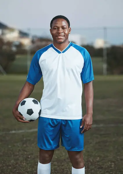 Soccer ball, ready or portrait of black man on field with smile in sports training, game or match on pitch. Happy football player, fitness or proud African athlete in practice, exercise or workout.