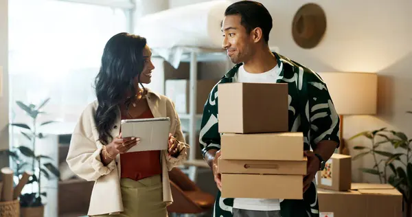 Creative people, tablet and boxes in logistics, teamwork or small business together at boutique. Man or woman in startup, box or technology for parcel delivery or packages in customer service at shop.