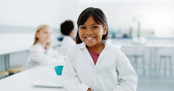 Portrait, girl and child in laboratory for science, knowledge or learning about chemistry with smile and lab coat. Face, student and kid with happiness in classroom, workshop or academy for education.