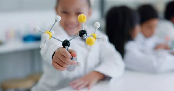Child, molecular structure and education, learning science or knowledge in classroom or school laboratory. Student kid portrait with atom or molecule model for scientist, project and happy physics.