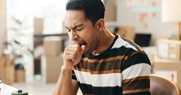 Yawning, man and tired with shipping small business, delivery company and brain fog with company owner. Exhausted, burnout and inventory check, supply chain and overtime with overworked worker.