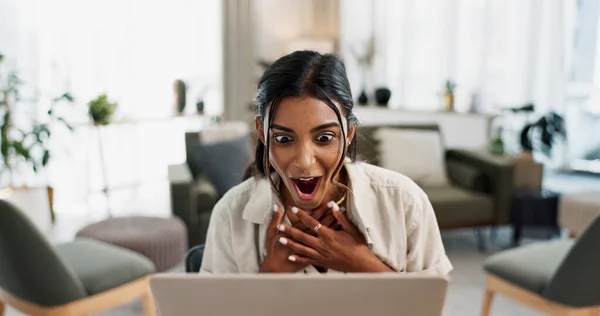 Excited woman, laptop and surprise for good news, winning or bonus promotion at home office. Shocked female person or freelancer smile in wow or omg for lottery, prize or sale discount on promo deal.