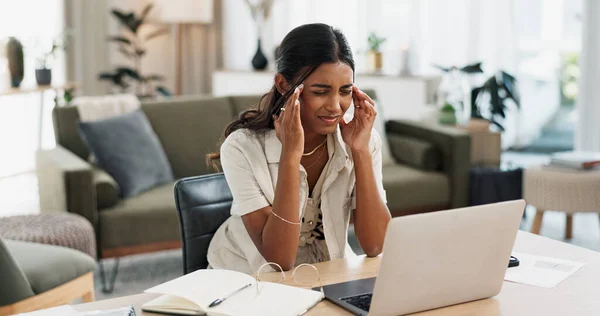 stock image Remote work, headache and woman in home office with laptop, stress or brain fog at house. Freelance, anxiety or lady entrepreneur online in living room with vertigo, disaster or 404, glitch or crisis.